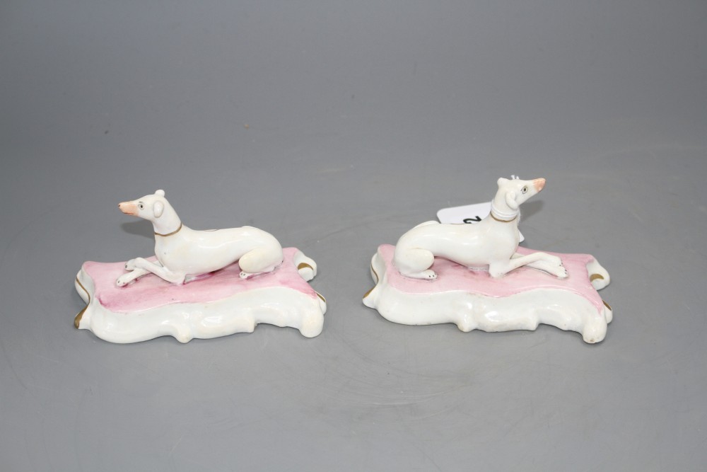 A pair of Staffordshire porcelain figures of recumbent greyhounds, c.1835-50, L. 12.2cm